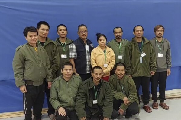In this photo provided by Thailand's Foreign Ministry, ten of freed Thai hostages and an officer, fourth from left, pose for a photo at the Shamir Medical Center in Israel Friday, Nov. 24, 2023. Hamas freed 10 Thai nationals seized in the group’s surprise attack on southern Israel last month, releasing them alongside Israeli hostages who were part of the first swap under a new cease-fire deal.(Thailand's Foreign Ministry via AP )