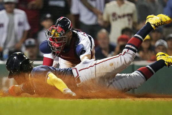 Atlanta Braves' Ronald Acuna Jr. beats the tag by Boston Red Sox catcher Kevin Plawecki to score on a two RBI single by Austin Riley during the 11th inning of a baseball game, Tuesday, Aug. 9, 2022, in Boston. (AP Photo/Charles Krupa)