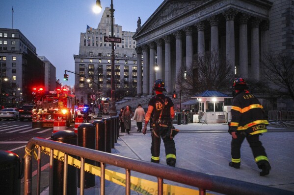 New York firefighters walk up to the entrance of New York Supreme Court, Wednesday, Dec. 13, 2023, in New York. The courthouse in New York City where former President Donald Trump's civil business fraud trial has been taking place was evacuated Wednesday hours after testimony had concluded for the day. (AP Photo/Robert Bumsted)