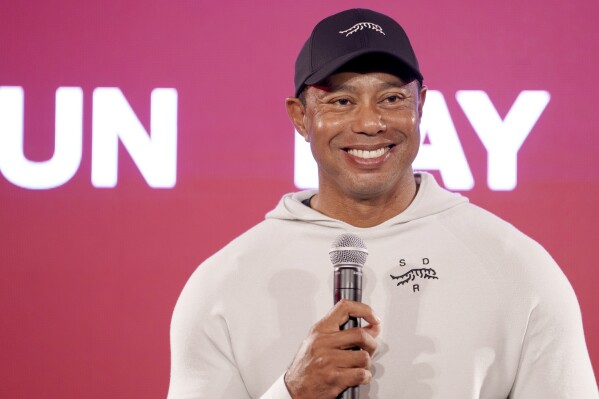 Tiger Woods smiles at a news conference ahead of the Genesis Open golf tournament, Monday, Feb. 12, 2024, in the Pacific Palisades area of Los Angeles. (AP Photo/Eric Thayer)
