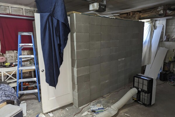 This undated photo provided by the Federal Bureau of Investigation's Portland Field Office shows a makeshift cinderblock cell in Klamath Falls, Ore. allegedly used by 29-year-old, Negasi Zuberi. Authorities say Zuberi who posed as an undercover police officer kidnapped a woman in Seattle, drove her hundreds of miles to his home in Oregon, and kept her in a makeshift cell from which she eventually escaped and found help. The FBI said Tuesday, Aug. 1, 2023, that police in Reno, Nevada, arrested Zuberi after he fled from his home in Klamath Falls, Oregon, where he had taken the Seattle woman. (FBI via AP)