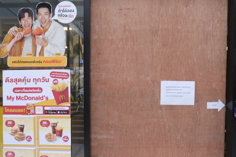A sign on the door of a McDonald's after earlier problems in the fast food restaurant, in Bangkok, Friday, March 15, 2024. System failures at McDonald’s have been reported worldwide, shuttering some restaurants for hours and leading to social media complaints. The fast food chain called the problems Friday a “technology outage” that is being fixed and apologized for the inconvenience. The Chicago-based burger giant said the problems aren't related to a cybersecurity issue. McDonald’s in Japan posted on X, formerly Twitter, that “operations are temporarily out at many of our stores nationwide.” (AP Photo/ David Cohen)