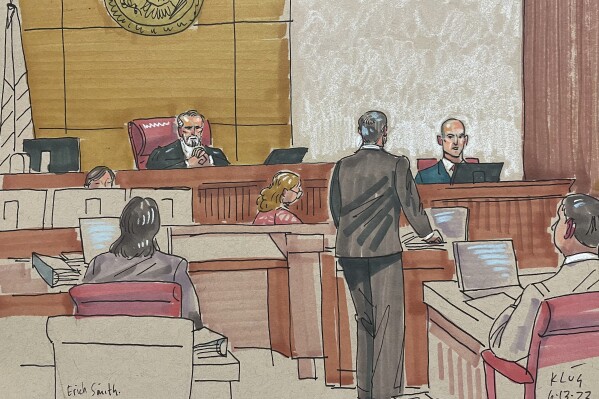 In this courtroom sketch, Erich Smith testifies Tuesday, June 13, 2023, in Pittsburgh, in the federal trial of Robert Bowers. Bowers is accused of shooting to death 11 worshippers in a synagogue more than four years ago, the deadliest antisemitic attack in U.S. history. (AP Photo/David Klug)