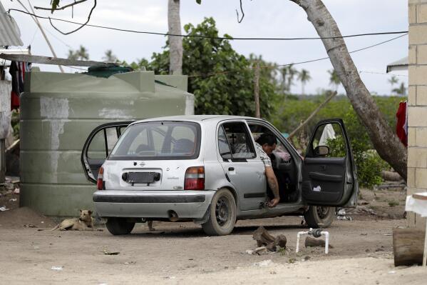 FILE - A man prepares to drive his car Nuku'alofa, Tonga, Sunday April 7, 2019. The island nation of Tonga has reported its first-ever case of COVID-19, Friday Oct. 29, 2021 after a traveler from New Zealand tested positive. (AP Photo/Mark Baker, File)