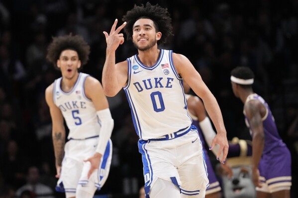 Duke guard Jared McCain (0) and guard Tyrese Proctor (5) reacts after McCain scored a 3-point basket during the first half of a second-round college basketball game against James Madison in the NCAA Tournament, Sunday, March 24, 2024, in New York. (AP Photo/Mary Altaffer)