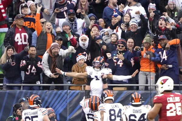Chicago Bears quarterback Justin Fields celebrates his touchdown with teammates during the first half of an NFL football game against the Arizona Cardinals Sunday, Dec. 24, 2023, in Chicago. (AP Photo/David Banks)