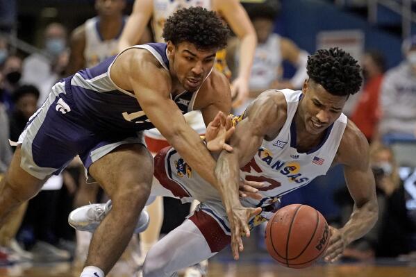 Kansas State guard Mark Smith, left, and Kansas guard Ochai Agbaji (30) chase a loose ball during the second half of an NCAA college basketball game Tuesday, Feb. 22, 2022, in Lawrence, Kan. Kansas won 102-83. (AP Photo/Charlie Riedel)