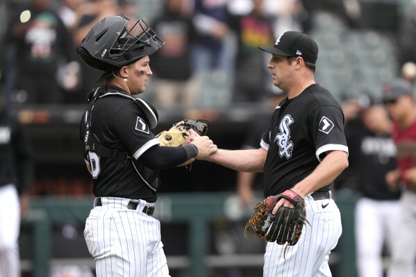 Chicago White Sox catcher Korey Lee and relief pitcher Bryan Shaw celebrate the team's 3-1 win over the Arizona Diamondbacks in a baseball game Thursday, Sept. 28, 2023, in Chicago. (AP Photo/Charles Rex Arbogast)