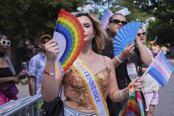 Bella Bautista, 22, a trans woman, attends the World Pride Parade with Jae Douglas, 21, right, who identifies as a trans femme, Saturday, June 7, 2025, in Washington. A resident of Georgia, she’s wearing a sash from her time in the Miss Supranational USA pageant, in which she represented Tennessee. (AP Photo/Jacquelyn Martin)