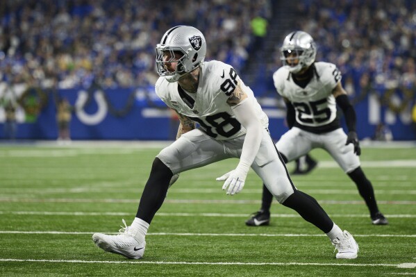 FILE - Las Vegas Raiders defensive end Maxx Crosby (98) lines up for a play during the team's NFL football game against the Indianapolis Colts, Dec. 31, 2023, in Indianapolis. Crosby is getting a $6 million raise this season and an additional $1.2 million next year, according to someone with knowledge of the deal. (AP Photo/Zach Bolinger, File)