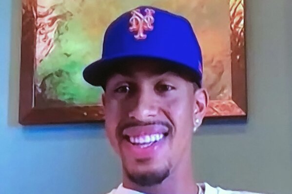 This screen grab from a Zoom call on Monday, Jan. 11, 2021, shows four-time All-Star Francisco Lindor smiling while wearing a New York Mets baseball team hat. Lindor was traded to the Mets from the Cleveland Indians.(New York Mets via AP)