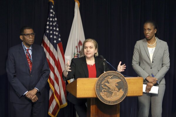 Dr. Allison Arwady, Commissioner, Chicago Department of Public Health, center, speaks at a news conference Thursday, Jan. 30, 2020, in Chicago, where it was announced that the first U.S. case of person-to-person spread of the new virus from China involves the man married to the Chicago woman who got sick from the virus after she returned from a trip to Wuhan, China. Joining Arwady from left are, Dr. Terry Mason, Cook County Department of Public Health Chief Operating Officer and Dr. Ngozi Ezike, director of the Illinois Department of Public Health. (AP Photo/Teresa Crawford)