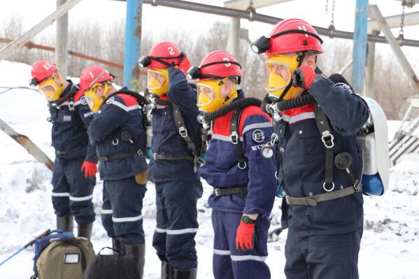 In this Russian Emergency Situations Ministry Thursday, Nov. 25, 2021 photo, rescuers prepare to work at a fire scene at a coal mine near the Siberian city of Kemerovo, about 3,000 kilometres (1,900 miles) east of Moscow, Russia,. Russian authorities say a fire at a coal mine in Siberia has killed nine people and injured 44 others. Dozens of others are still trapped. A Russian news agency says the blaze took place in the Kemerovo region in southwestern Siberia. (Russian Ministry for Emergency Situations photo via AP)