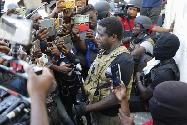 Jimmy Chérizier, a former elite police officer known as Barbecue who now runs a gang federation, speaks to journalists in the Delmas 6 neighborhood of Port-au-Prince in Port-au-Prince, Haiti, Tuesday, March 5, 2024. (AP Photo/Odelyn Joseph)