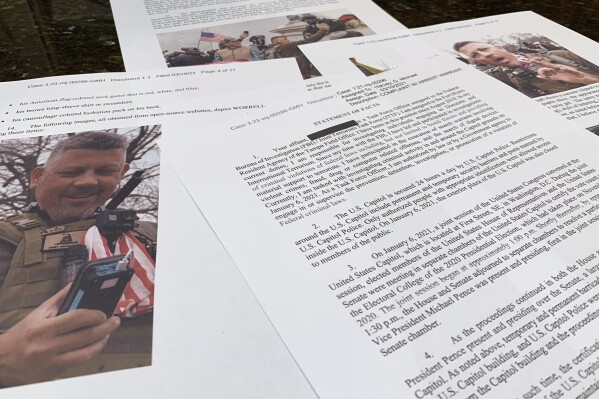 FILE - This photo shows part of the Justice Department's statement of facts in the complaint and arrest warrant for Christopher Worrell. Worrell, a member of the Proud Boys extremist group who went on the run after he was convicted of assaulting police with pepper spray in the Jan. 6 attack at the U.S. Capitol and then allegedly faked a drug overdose after he was caught was sentenced to 10 years in prison on Thursday, Jan. 4, 2024. (AP Photo/Jon Elswick, File)
