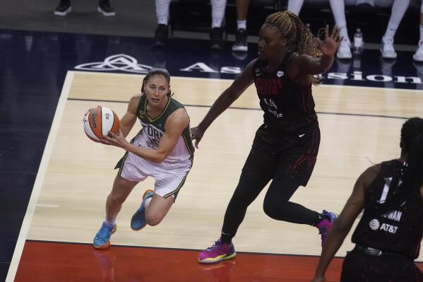 Seattle Storm's Sue Bird drives as Indiana Fever's Jantel Lavender defends during the second half of a WNBA basketball game Thursday, June 17, 2021, in Indianapolis. (AP Photo/Darron Cummings)