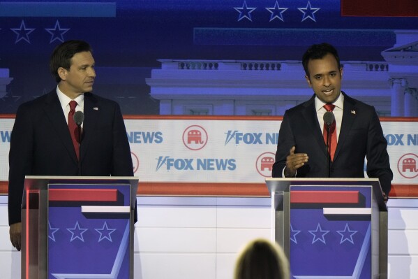 Businessman Vivek Ramaswamy speaks as Florida Gov. Ron DeSantis listens during a Republican presidential primary debate hosted by FOX News Channel Wednesday, Aug. 23, 2023, in Milwaukee. (AP Photo/Morry Gash)