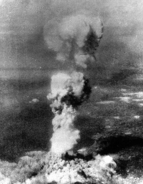 FILE - In this Aug. 6, 1945, file photo released by US Air Force, a column of smoke rises 20,000 feet over Hiroshima, western Japan, after the first atomic 5-ton "Little Boy" bomb was released. Hiroshima was targeted because it was a major Japanese military hub filled with military bases and ammunition facilities. The city of Hiroshima on Thursday, Aug. 6, 2020 marks the 75th anniversary of the world’s first nuclear attack. (George R. Caron/US Air Force via AP, File)