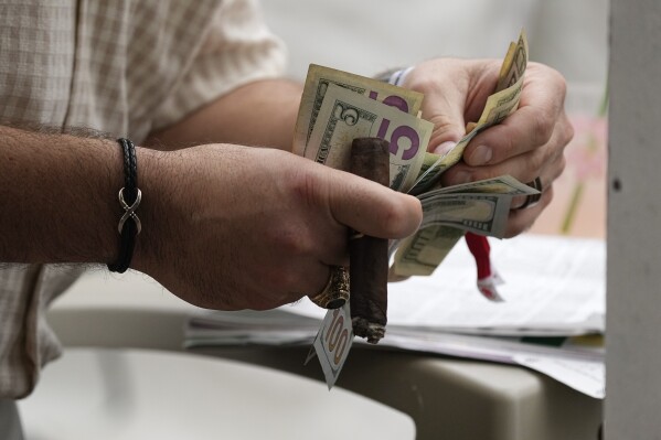 FILE - A spectator places a bet before the 148th running of the Kentucky Derby horse race at Churchill Downs Saturday, May 7, 2022, in Louisville, Ky. The firing of Los Angeles Dodgers star Shohei Ohtani's interpreter and close friend after allegations of illegal gambling and theft from the Japanese baseball player is shining renewed attention on compulsive gambling. The National Council on Problem Gambling describes it as gambling that is damaging to a person or their family, often disrupting their daily life and career. (AP Photo/Charlie Riedel, File)