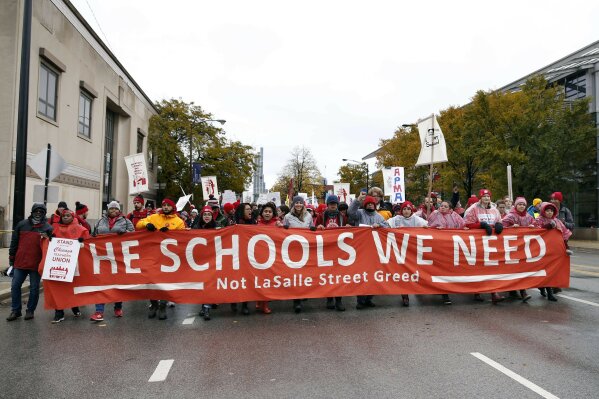 Chicago Teachers Union members and supporters march on Roosevelt Road, Wednesday, Oct. 30, 2019, in Chicago. (Kevin Tanaka/Chicago Sun-Times via AP)