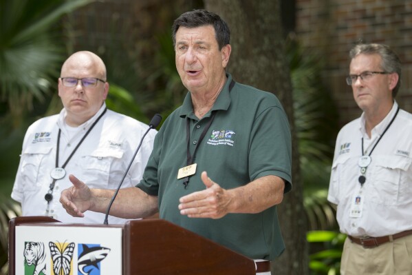 FILE - President and CEO of the Audubon Nature Institute Ron Forman, center, speaks during a news conference at the Audubon Zoo, July 14, 2018, in New Orleans. Forman, who is credited with transforming New Orleans’ Audubon Zoo from a wretched “animal prison” to a world-renowned showcase, will retire at the end of 2024, the Audubon Nature Institute announced Thursday, Aug. 17, 2023. (Brett Duke/The Times-Picayune/The New Orleans Advocate via AP, File)