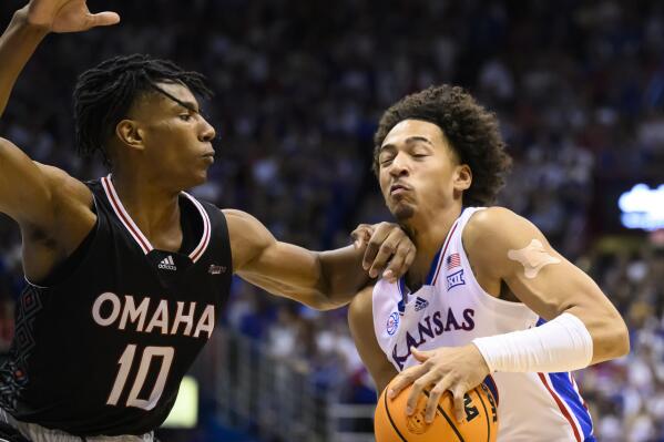 Kansas forward Jalen Wilson (10) drives against Omaha forward Marquel Sutton (10) during the first half of an NCAA college basketball game in Lawrence, Kan., Monday, Nov. 7, 2022. (AP Photo/Reed Hoffmann)