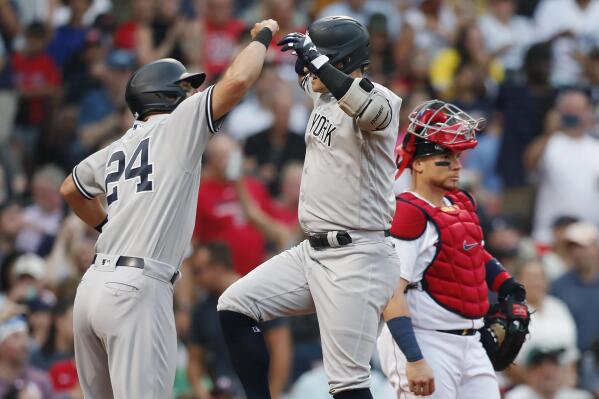 New York Yankees' Josh Donaldson celebrates his three-run home run with Matt Carpenter (24) during the first inning of a baseball game against the Boston Red Sox on Friday, July 8, 2022, in Boston. (AP Photo/Michael Dwyer)