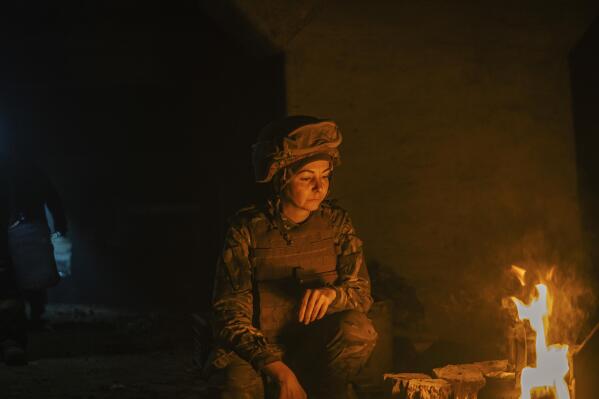 In this photo provided by Azov Special Forces Regiment of the Ukrainian National Guard Press Office, A Ukrainian woman soldier inside the ruined Azovstal steel plant take a rest in his shelter in Mariupol, Ukraine, May 10, 2022. For nearly three months, Azovstal’s garrison clung on, refusing to be winkled out from the tunnels and bunkers under the ruins of the labyrinthine mill. A Ukrainian soldier-photographer documented the events and sent them to the world. Now he is a prisoner of the Russians. His photos are his legacy.(Dmytro Kozatsky/Azov Special Forces Regiment of the Ukrainian National Guard Press Office via AP)