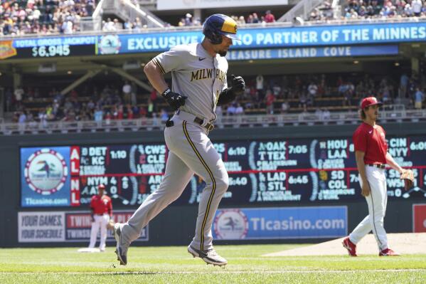 Milwaukee Brewers' Jace Peterson jogs home after hitting a solo home run off Minnesota Twins pitcher Joe Ryan, right, in the third inning of a baseball game, Wednesday, July 13, 2022, in Minneapolis. (AP Photo/Jim Mone)