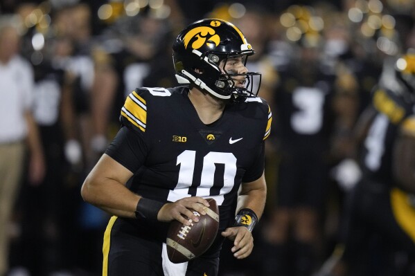 Iowa quarterback Deacon Hill (10) looks to pass during the first half of an NCAA college football game against Michigan State, Saturday, Sept. 30, 2023, in Iowa City, Iowa. (AP Photo/Charlie Neibergall)