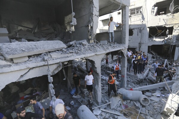 FILE - Palestinians look for survivors after Israeli airstrikes in Gaza City, Gaza Strip, Wednesday, Oct. 18, 2023. Many Palestinians in Gaza who heeded the Israeli military's warnings last week advising them to head south thought they were fleeing to a safer place. But they watched as dozens of people like them met the same grim fate they were running from: killed by Israeli airstrikes raining down on residential towers and United Nations shelters, outside the evacuation zone. (AP Photo/Abed Khaled, File)