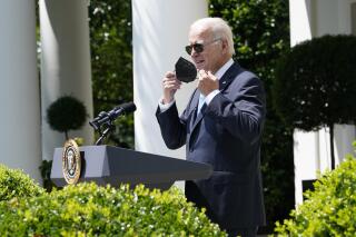 President Joe Biden takes off his mask as he starts to speak in the Rose Garden of the White House in Washington, Wednesday, July 27, 2022. Biden was returning to working in the Oval Office after recovering from COVID-19. (AP Photo/Susan Walsh)