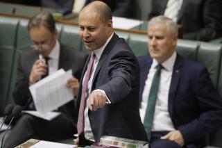 FILE - In this July 4, 2019, file photo Australia's Treasurer Josh Frydenberg speaks in Parliament in Canberra. Frydenberg on Thursday, Oct. 7, 2021, welcomed France's decision to return it ambassador to Australia and said they hoped the two nations could repair the damage from a cancelled submarine contract. (AP Photo/Rod McGuirk, File)