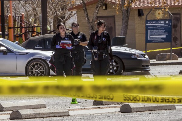 Crime scene technicians investigate the parking lot at Young Park after Friday night's fatal shooting in Las Cruces, N.M., on Saturday, March 22, 2025. (Chancey Bush/The Albuquerque Journal via AP)