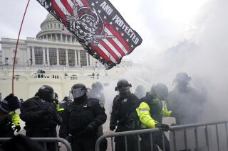FILE - In this Jan. 6, 2021, file photo police hold off supporters of Donald Trump who tried to break through a police barrier at the Capitol in Washington. House Speaker Nancy Pelosi has told Democratic colleagues that she will create a new committee to investigate the Jan. 6 insurrection at the Capitol. (AP Photo/Julio Cortez, File)