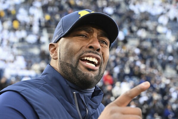 Michigan acting head coach Sherrone Moore celebrates a 24-15 win over Penn State following an NCAA college football game, Saturday, Nov. 11, 2023, in State College, Pa. (AP Photo/Barry Reeger)