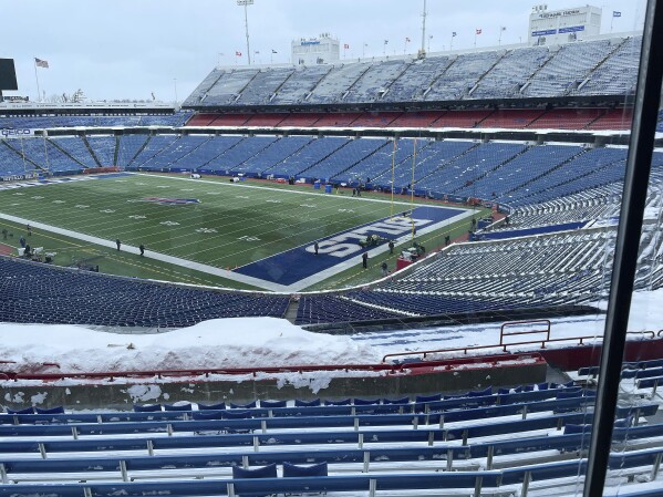 A few flurries fall at the stadium mostly-cleared of snow in Orchard Park, N.Y, ahead of the NFL football game between the Buffalo Bills and Kansas City Chiefs, Sunday, Jan. 21, 2024. (AP Photo/John Wawrow)