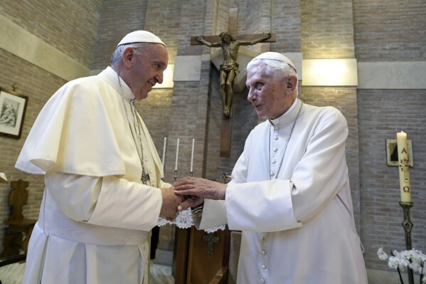 FILE - Pope Francis, left, and Pope Benedict XVI, meet each other on the occasion of the elevation of five new cardinals at the Vatican, on June 28, 2017. Pope Francis has exposed the political “maneuvers” to sway votes during the past two conclaves and denied he is planning to reform the process to elect a pope in a new book-length interview published Tuesday April 2, 2024. (L'Osservatore Romano/Pool photo via AP, File)