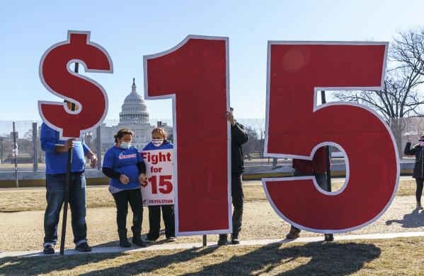 FILE - Activists appeal for a $15 minimum wage near the Capitol in Washington, Thursday, Feb. 25, 2021. According to the Economic Policy Institute, the federal minimum wage in 2021 was worth 34% less than in 1968, when its purchasing power peaked. (AP Photo/J. Scott Applewhite, File)