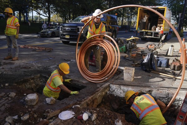 FILE - Workmen prepare to replace older water pipes with a new copper one in Newark, N.J., Oct. 21, 2021. The Environmental Protection Agency will soon strengthen lead in drinking water regulations.(AP Photo/Seth Wenig, File)