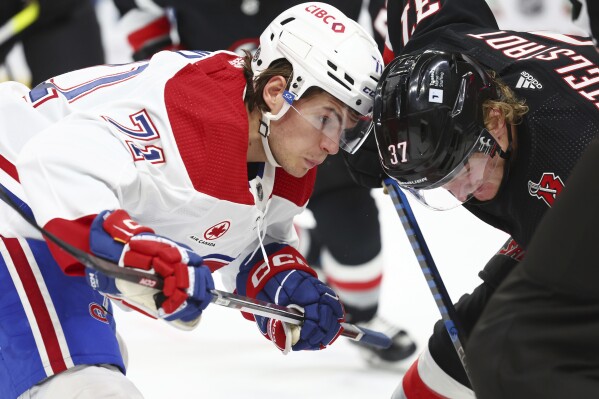 Montreal Canadiens center Jake Evans (71) and Buffalo Sabres center Casey Mittelstadt (37) work for position during the second period of an NHL hockey game Saturday, Dec. 9, 2023, in Buffalo, N.Y. (APPhoto/Jeffrey T. Barnes)