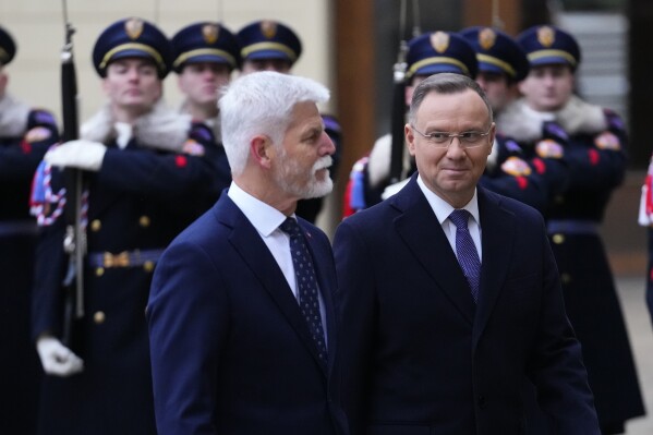Czech Republic's President Petr Pavel, left, welcomes Poland's President Andrzej Duda, right, for the V4 Summit in Prague, Czech Republic, Wednesday, Nov. 22, 2023. (AP Photo/Petr David Josek)