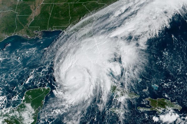 FILE - This GOES-East GeoColor satellite image taken at 9:56 a.m. EDT on Tuesday, Sept. 27, 2022, and provided by the National Oceanic and Atmospheric Administration (NOAA), shows Hurricane Ian passing over western Cuba. The familiar “cone of uncertainty” produced by the National Hurricane Center to forecast the location and ferocity of a tropical storm is getting an update this year to include predicted impacts in inland areas, where wind and flooding are sometimes more treacherous than damage to the coasts. (NOAA via AP, File)