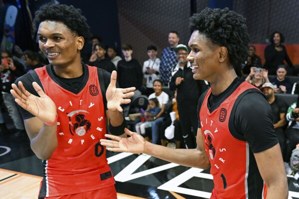 In this handout provided by Overtime Elite, Ausar Thompson, left, and Amen Thompson of the City Reapers celebrate after an Overtime Elite Finals basketball game on Saturday, March 4, 2023, at OTE Arena in Atlanta. The 6-foot-7 guards out of Overtime Elite are projected in the AP mock draft to be selected early Thursday night, which could make them the first set of twins taken in the top 10 of the same NBA draft class. (Adam Hagy/Overtime Elite via AP)