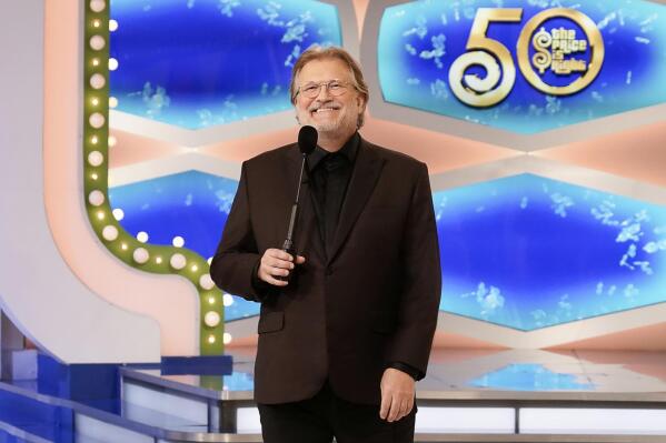 This image released by CBS Entertainment shows host Drew Carey on the set of "The Price Is Right." The long-running game show is hitting the road with the “Come On Down Tour", making 50 stops on a coast-to-coast tour for anyone who can’t make the trip to the Los Angeles studio. The tour will kick off Friday at the Santa Monica Pier and will make stops in such cities as Denver, Dallas, New Orleans, Nashville and St. Louis. (Adam Torgerson/CBS Entertainment via AP)