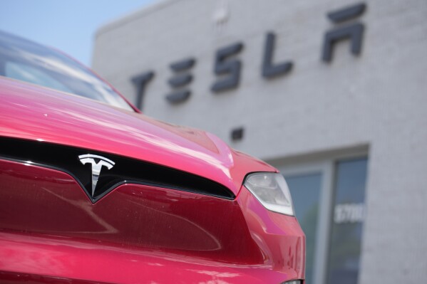 FILE - A Model X sports-utility vehicle sits outside a Tesla store in Littleton, Colo., June 18, 2023. Shares of Tesla stock rallied Monday, April 29, 2024, after the electric vehicle maker's CEO, Elon Musk, paid a surprise visit to Beijing over the weekend and reportedly won tentative approval for its driving software. (AP Photo/David Zalubowski, File)