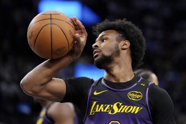 Los Angeles Lakers guard Bronny James grabs the ball after the Los Angeles Clippers scored during the second half of an NBA basketball game, Sunday, Jan. 19, 2025, in Inglewood, Calif. (AP Photo/Mark J. Terrill)
