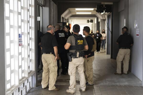Federal agents wait for news of their injured colleagues outside the Rio Piedras Medical Center in San Juan, Puerto Rico, Thursday, Nov. 17, 2022, who were airlifted from the coast of Cabo Rojo, a major drug smuggling corridor for cocaine coming out of South America known as the Mona Passage.  A U.S. Customs and Border Protection agent and a suspected smuggler died during a shootout Thursday off the Puerto Rican coast, authorities said. (Courtesy of Carlos Giusti/GFR MEDIA via AP)