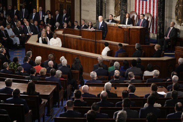 President Joe Biden speaks during the State of the Union address on Capitol Hill, Thursday, March 7, 2024, in Washington, as Vice President Kamala Harris and House Speaker Mike Johnson of La., listen. (AP Photo/Mark Schiefelbein)