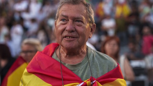 A supporter of VOX far right party wrapped in a Spanish flag attends an election campaign event in Guadalajara, Spain, Saturday, July 15, 2023. Spain's general election Sunday, July 23 could make the country the latest European Union member to shift to the political right. Most polls put the right-wing Popular Party ahead of the Socialists but likely needing the support of the extreme right Vox party to form a government. (AP Photo/Manu Fernandez)